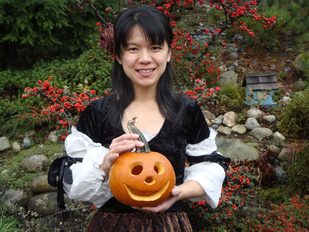 West Vancouver's piano teacher and early childhood educator Yuki is holding her Halloween pumpkin outside her piano studio.